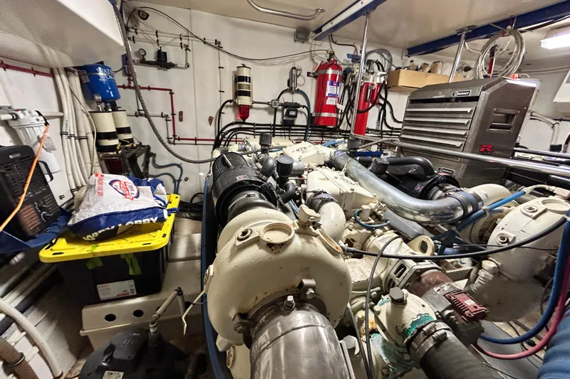 Nother Venture Yacht Photos Pics Engine room of 1989 Hatteras 78 CPMY yacht, featuring complex machinery and equipment.