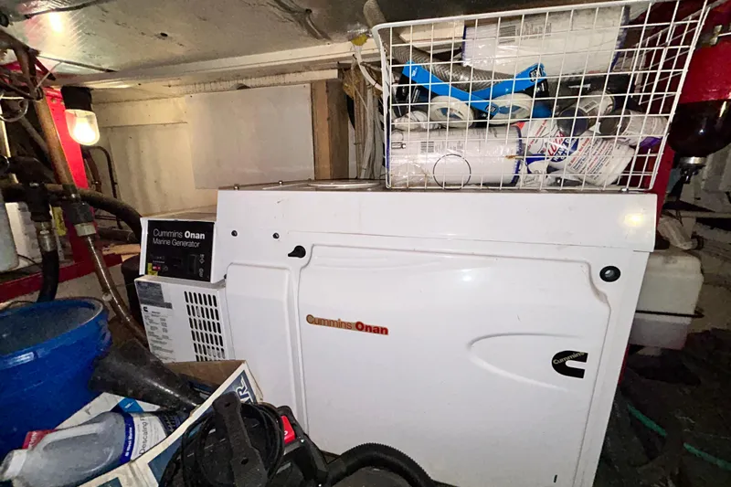 Nother Venture Yacht Photos Pics Cummins Onan marine generator in 1989 Hatteras 78 CPMY engine room, surrounded by supplies.