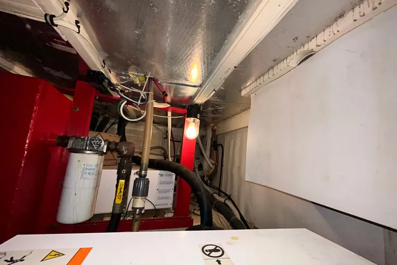 Nother Venture Yacht Photos Pics Engine room of 1989 Hatteras 78 CPMY yacht with visible wiring and components.