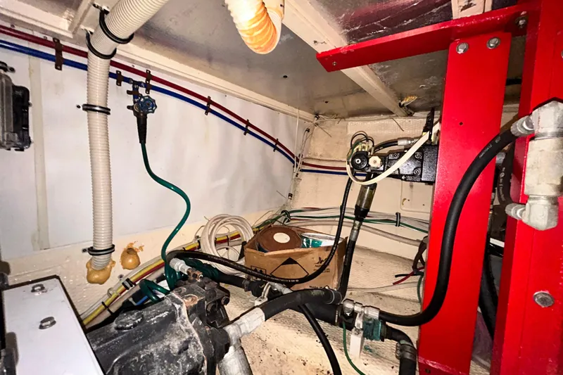 Nother Venture Yacht Photos Pics Engine room of 1989 Hatteras 78 CPMY yacht with visible pipes and wiring.