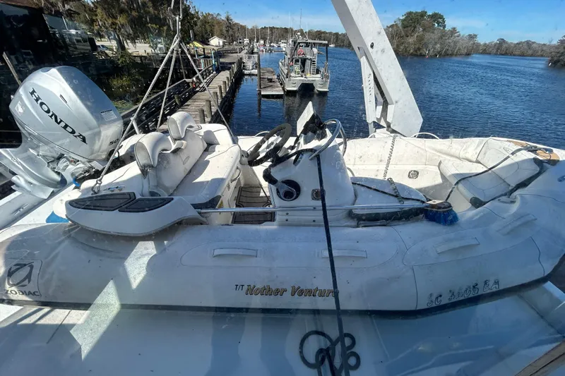 Nother Venture Yacht Photos Pics 1989 Hatteras 78 CPMY yacht with Zodiac tender and Honda outboard motor on deck.