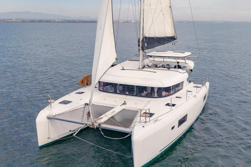 Hopena Yacht Photos Pics 2018 Lagoon 42 catamaran sailing on calm waters.