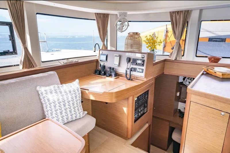 Hopena Yacht Photos Pics Interior of 2018 Lagoon 42 catamaran with modern navigation equipment and cozy seating area.