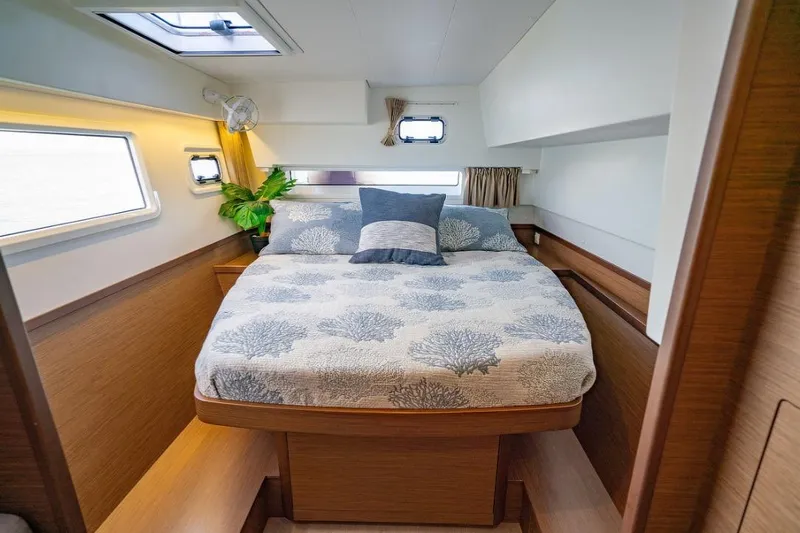 Hopena Yacht Photos Pics Luxurious cabin interior of 2018 Lagoon 42 catamaran with cozy bed and natural light.
