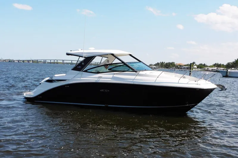 Not Guilty Yacht Photos Pics 2018 Sea Ray Sundancer 320 boat on calm water under a clear sky.