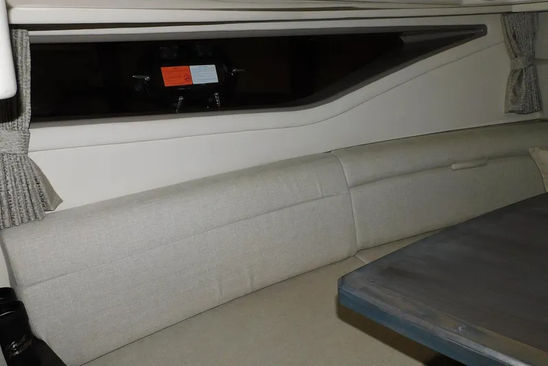 Not Guilty Yacht Photos Pics Interior of 2018 Sea Ray Sundancer 320, featuring a cozy seating area and window.