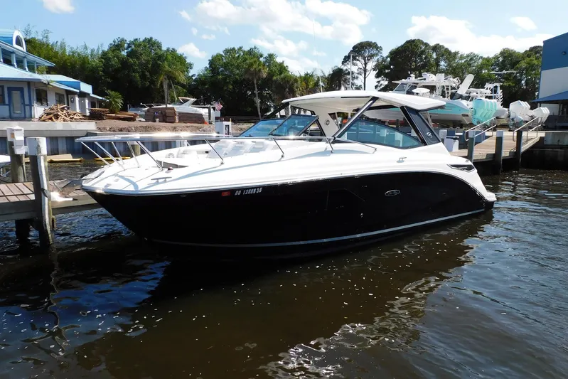 Not Guilty Yacht Photos Pics 2018 Sea Ray Sundancer 320 docked at marina, sunny day, calm waters.