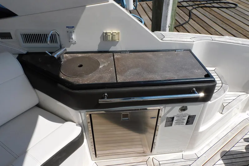 Not Guilty Yacht Photos Pics 2018 Sea Ray Sundancer 320 boat kitchenette with sink, countertop, and mini fridge.
