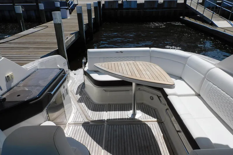Not Guilty Yacht Photos Pics 2018 Sea Ray Sundancer 320 yacht interior with white seating and wooden table.