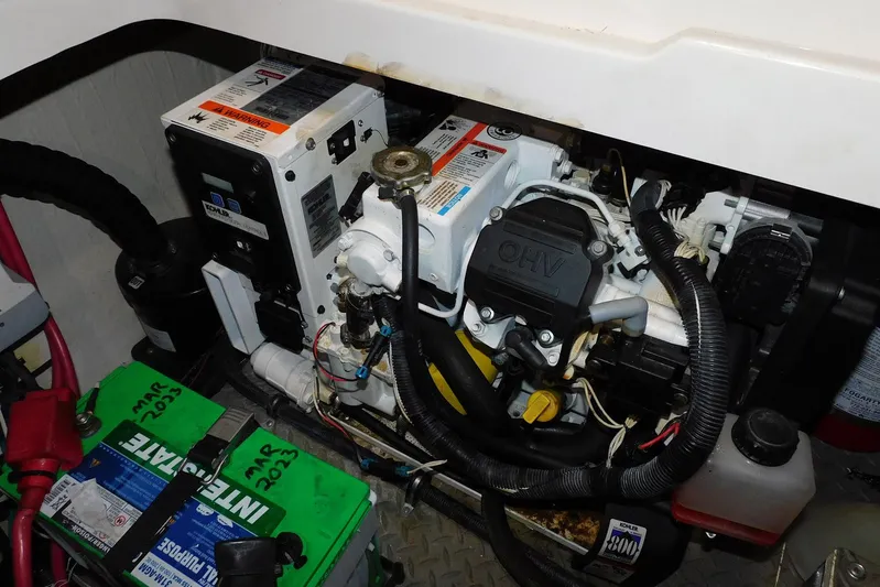 Not Guilty Yacht Photos Pics Engine compartment of 2018 Sea Ray Sundancer 320 with visible battery and generator components.