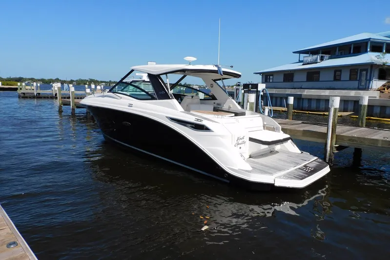 Not Guilty Yacht Photos Pics 2018 Sea Ray Sundancer 320 docked at marina, clear blue sky, calm water.