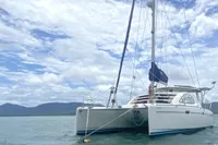 Sailing catamaran Leopard 40, 2009 model, anchored on calm waters under a cloudy sky.