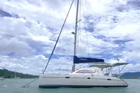 2009 Leopard 40 catamaran sailing on calm waters under a partly cloudy sky.