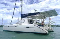 2009 Leopard 40 catamaran sailing on calm waters under a partly cloudy sky.