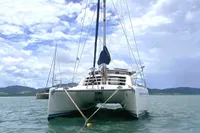 2009 Leopard 40 catamaran anchored in calm waters under a partly cloudy sky.