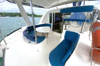 2009 Leopard 40 catamaran with blue seating, docked on calm water.
