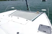 Front deck of a 2009 Leopard 40 catamaran on a calm lake.