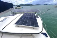 Leopard 40 catamaran with solar panels on deck, anchored in scenic bay, 2009 model.