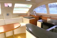 Interior of 2009 Leopard 40 catamaran with modern seating and kitchen area.