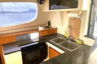 Modern kitchen interior of 2009 Leopard 40 catamaran with ocean view.