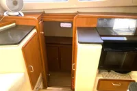 Interior of 2009 Leopard 40 yacht with wooden cabinets and modern kitchen appliances.