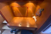 Cozy wooden interior of 2009 Leopard 40 yacht with decorative wall art.