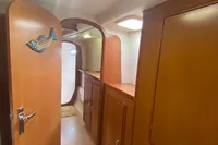 Interior of 2009 Leopard 40 yacht with wooden cabinetry and fish decor on door.