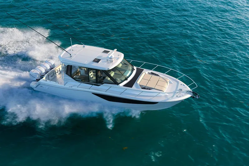  Yacht Photos Pics 2022 Boston Whaler 405 Conquest cruising on open water, aerial view.