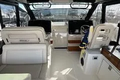  Yacht Photos Pics Interior of 2022 Boston Whaler 405 Conquest boat, featuring helm and seating area.