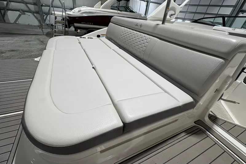  Yacht Photos Pics 2022 Sea Ray SDX 270 Outboard boat with luxurious white seating in a showroom.