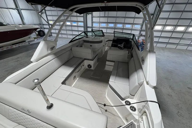  Yacht Photos Pics 2022 Sea Ray SDX 270 Outboard boat interior with spacious seating in a garage.