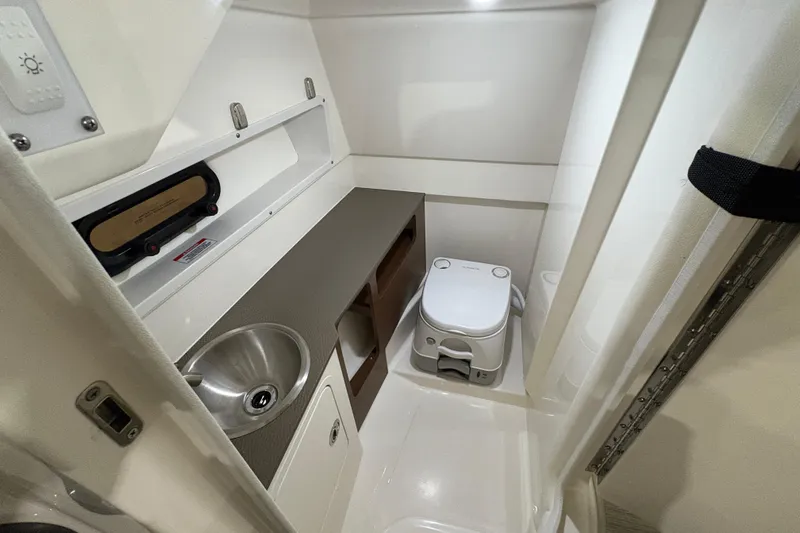  Yacht Photos Pics 2022 Sea Ray SDX 270 Outboard interior bathroom with sink and toilet.