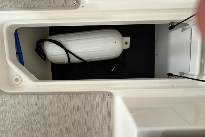  Yacht Photos Pics Storage compartment of 2022 Sea Ray SDX 270 Outboard with a white fender inside.