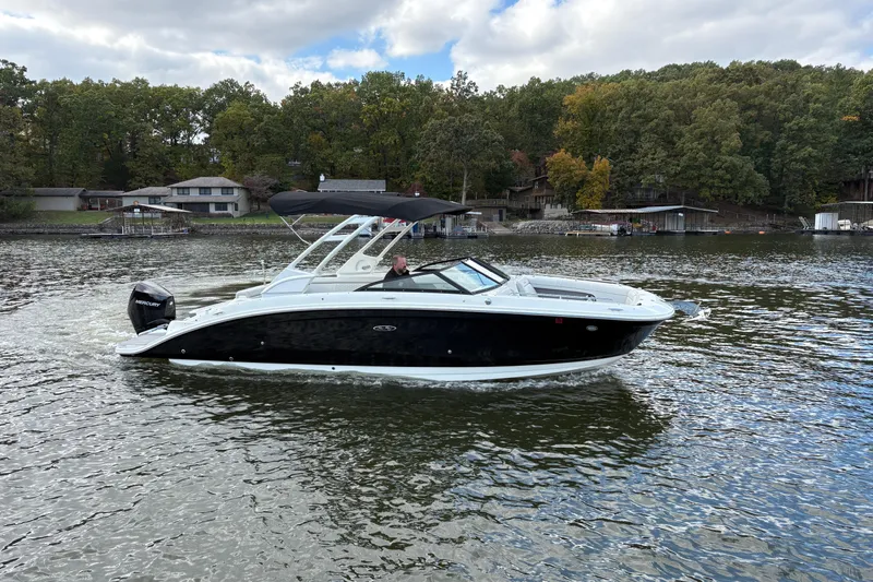  Yacht Photos Pics 2022 Sea Ray SDX 270 Outboard cruising on a scenic lake with wooded shoreline.