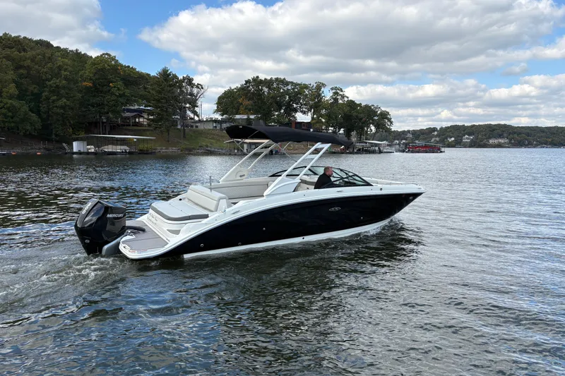  Yacht Photos Pics 2022 Sea Ray SDX 270 Outboard cruising on a scenic lake under a cloudy sky.