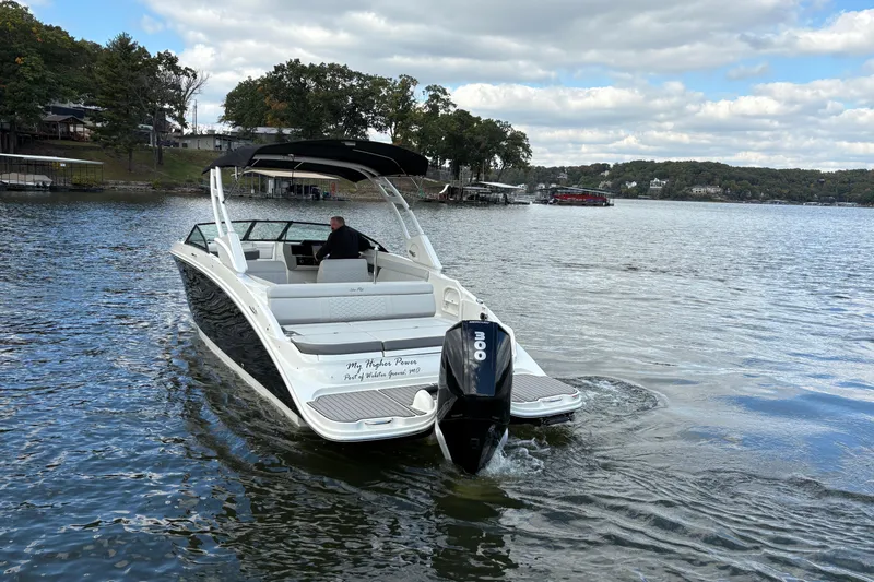  Yacht Photos Pics 2022 Sea Ray SDX 270 Outboard cruising on a scenic lake under a partly cloudy sky.