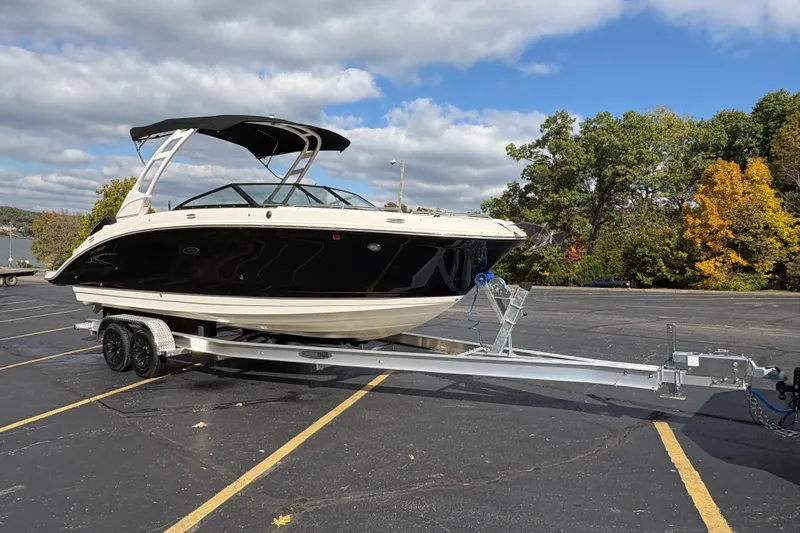  Yacht Photos Pics 2022 Sea Ray SDX 270 Outboard boat on trailer in parking lot, under cloudy sky.