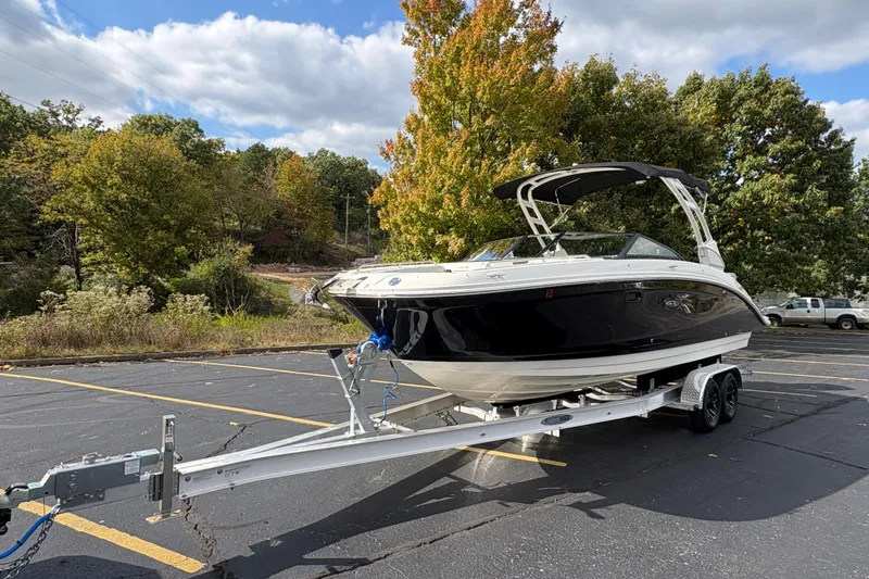  Yacht Photos Pics 2022 Sea Ray SDX 270 Outboard boat on trailer in parking lot, surrounded by trees.