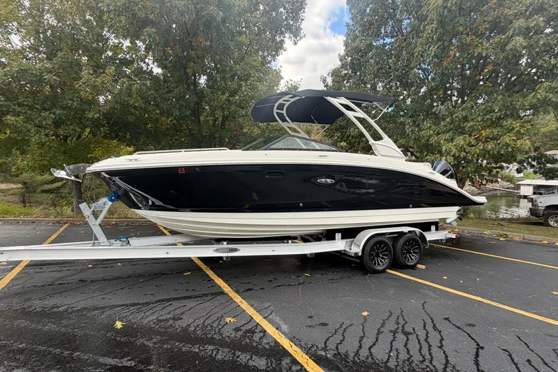  Yacht Photos Pics 2022 Sea Ray SDX 270 Outboard boat on trailer, parked in a lot with trees.