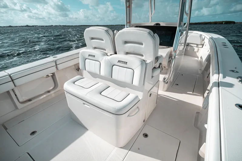  Yacht Photos Pics 2019 Jupiter 34FS boat interior with white seating, ocean view, and clear skies.