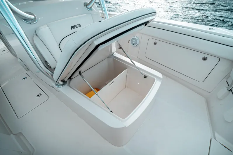  Yacht Photos Pics 2019 Jupiter 34FS boat with open storage compartment, showcasing sleek design and functionality.