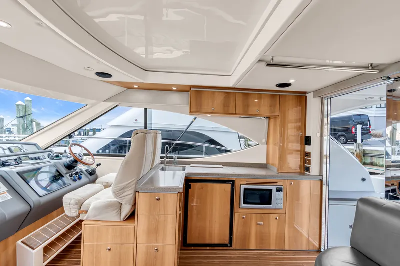 Ayeroller Yacht Photos Pics Interior of 2014 Riviera 44 Sport Yacht with modern kitchen and helm.