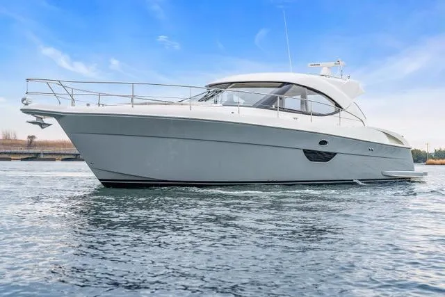 Ayeroller Yacht Photos Pics 2014 Riviera 4400 Sport Yacht on calm water under a clear blue sky.