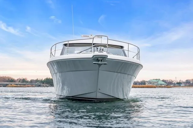Ayeroller Yacht Photos Pics 2014 Riviera 4400 Sport Yacht on calm water under a clear blue sky.