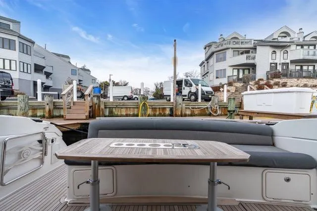 Ayeroller Yacht Photos Pics 2014 Riviera 4400 Sport Yacht docked, featuring a spacious outdoor seating area with a table.