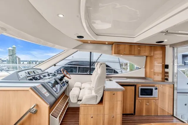 Ayeroller Yacht Photos Pics Luxurious interior of 2014 Riviera 4400 Sport Yacht with modern helm and kitchen amenities.