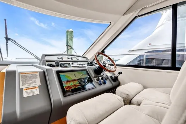 Ayeroller Yacht Photos Pics Interior of 2014 Riviera 4400 Sport Yacht with modern dashboard and steering wheel.