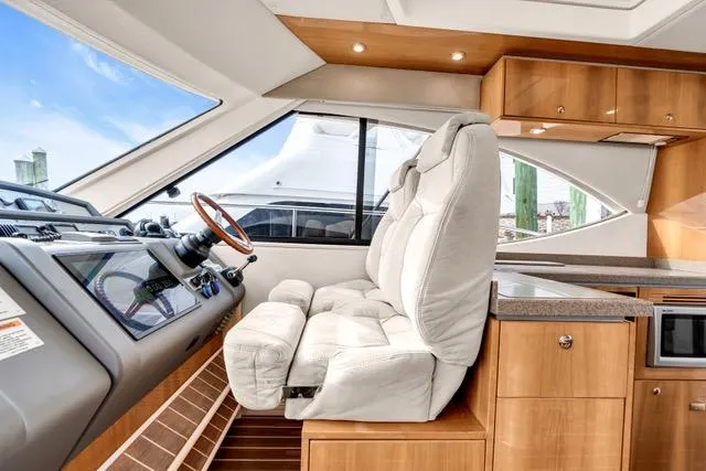 Ayeroller Yacht Photos Pics 2014 Riviera 4400 Sport Yacht interior with plush seating and modern helm.