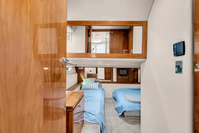 Ayeroller Yacht Photos Pics Interior of 2014 Riviera 4400 Sport Yacht with twin beds and wooden accents.