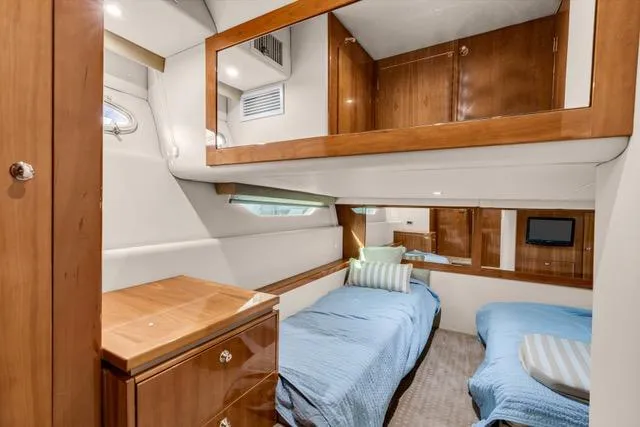 Ayeroller Yacht Photos Pics 2014 Riviera 4400 Sport Yacht cabin with twin beds, wooden cabinetry, and modern decor.